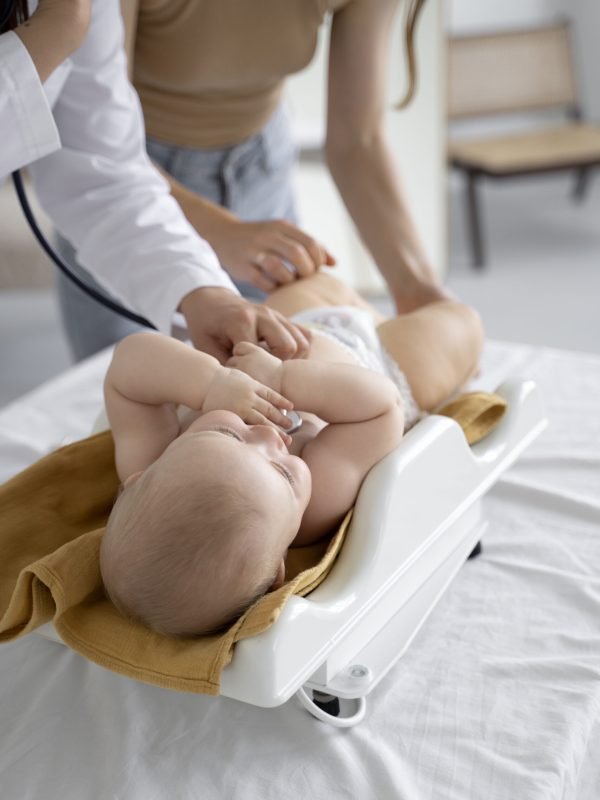 adult-taking-care-baby-weight